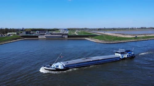 Inland Barge Vessel With Cover Cruising At Noord River Near Hendrik-Ido-Ambacht, Netherlands. - aeri