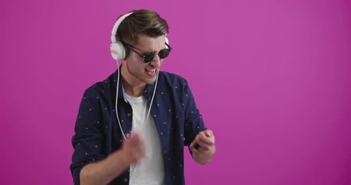 Young Man Dancing to Music with Headphones