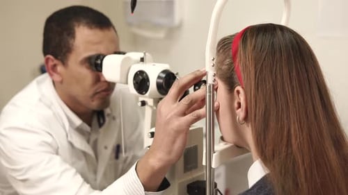 Medical Professional Examining Patient's Eyes