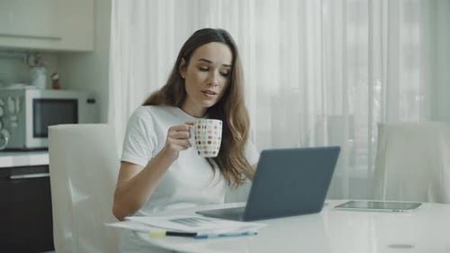 Young Woman Working on Laptop at Home