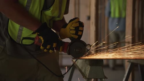 Construction Worker Cutting Metal with Sparks Flying
