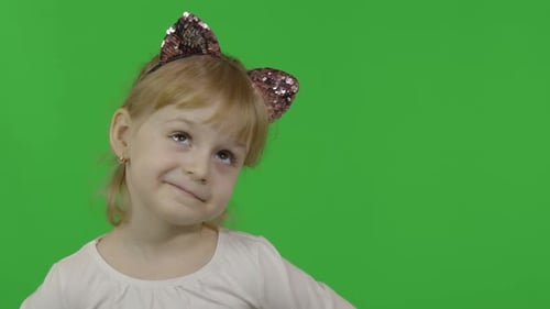 Smiling Child Wearing Cat Ears on Green Screen
