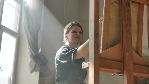 Woman in Black Shirt Draws Picture in Spacious Art Studio