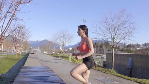 Woman doing stair climbing step up with knee raise exercise, Side View