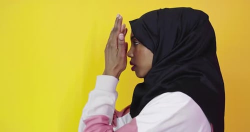Woman in Headscarf with Hands Raised