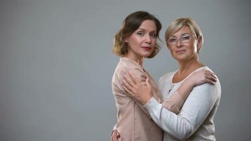 Mother and Daughter Embracing Affectionately in Studio