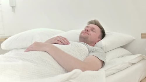 Long Shot of Man Sleeping in Bed