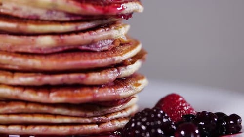 Delicious Pancakes Stacked High with Berry Sauce