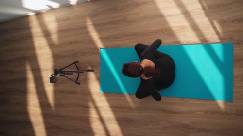 Woman Doing Yoga on Mat Overhead Shot