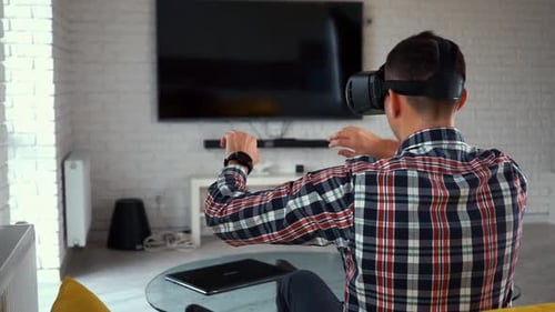 Man Immersed in Virtual Reality in Living Room