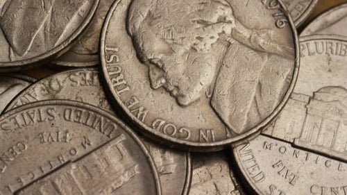 Rotating stock footage shot of American nickles (coin - $0.05)