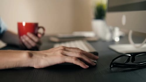 Hand Using Computer Mouse at Desk