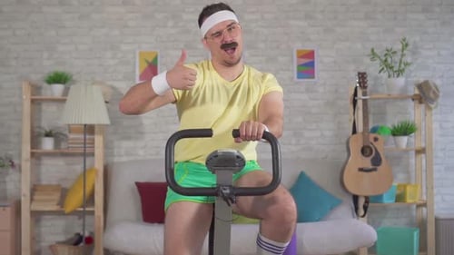 Man Doing Home Fitness on Stationary Bike