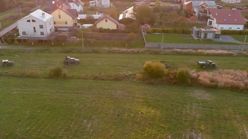 Military Vehicles Convoy Driving Across Grassy Field