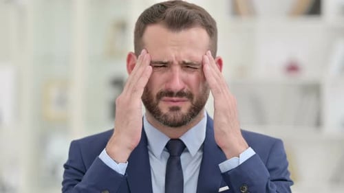 Man in Suit Shows Signs of Stress