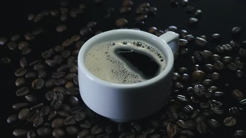 Coffee Cup and Beans Close Up Shot