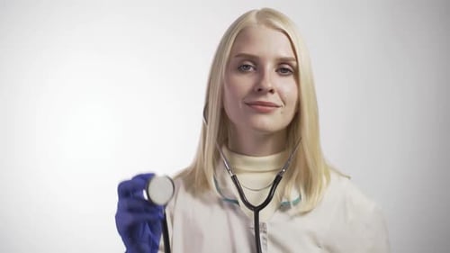 Female Doctor Holds Up Stethoscope, Close Up