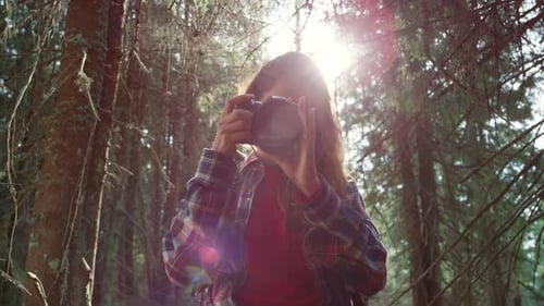 Woman Taking Photographs in the Forest