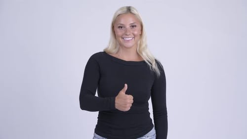 Young Woman Gives Thumbs Up Gesture
