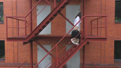 Businesswoman Climbing Up the Stairs of a Business Centre