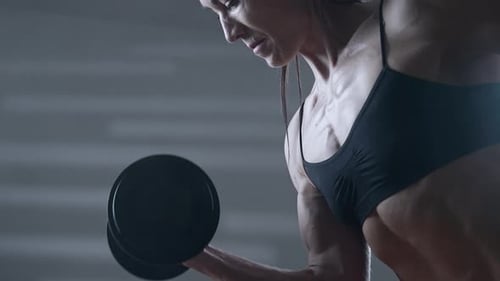 Strong Woman Lifting Weights in the Gym