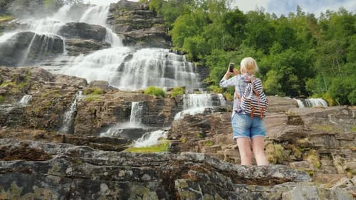 Womanphotographs the Highest Waterfall in Norway. According To Legend, the Water From This Waterfall
