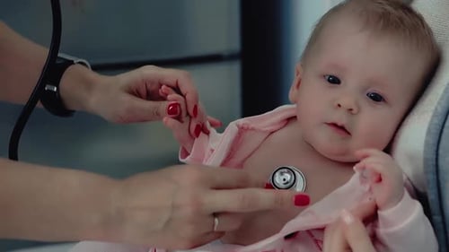 Infant Examined by Medical Professional with Stethoscope