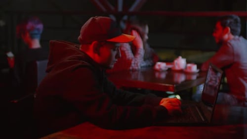 Young Man Using Computer in Bar