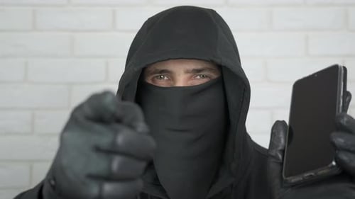 Hooded Figure Holding Smartphone and Pointing Finger