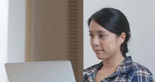 Young Adult Woman Working on Laptop Indoors