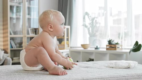 Blonde Baby Eating Green Apple