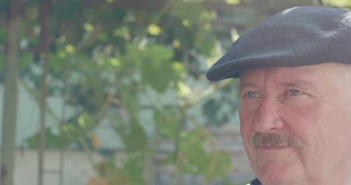 Mature Man with Mustache Wearing Cap Looking Left