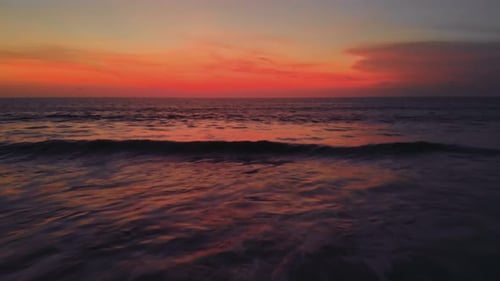 Flight at Sunset Overlooking the Indian Ocean in Bali Indonesia