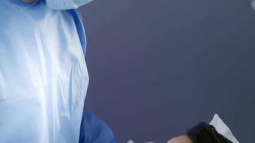 Medical Professional Giving Injection to Patient in Hospital
