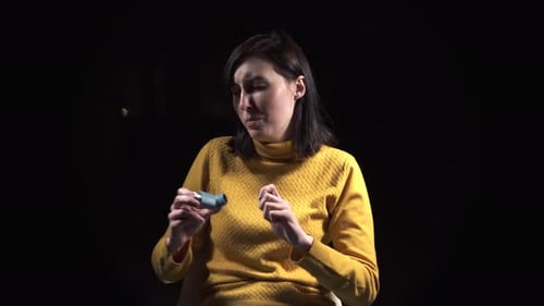 Woman Coughing Uses Inhaler for Breathing Relief