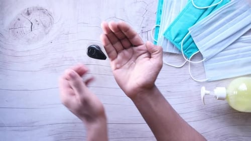 Top View of Young Man Hand Using Sanitizer Gel for Preventing Virus