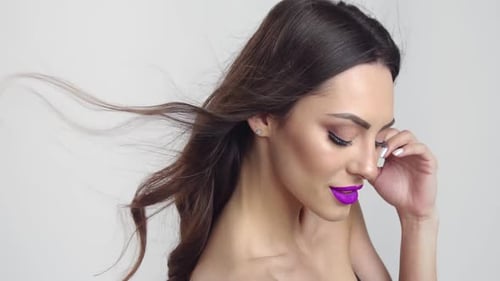 Glamorous Woman with Purple Lipstick Posing in Studio