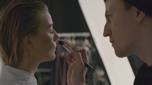 Makeup Artist Applying Makeup to Model in Studio
