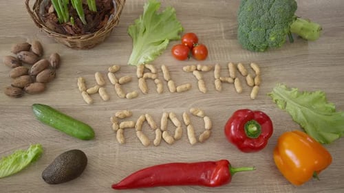 Top View Healthful Vegetables and Nuts on Table Indoors