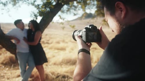 Back Close Up View Professional Photographer Making Pictures of Romantic Couple
