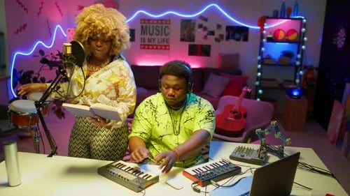 Musicians Compose Music in Neon Lit Studio