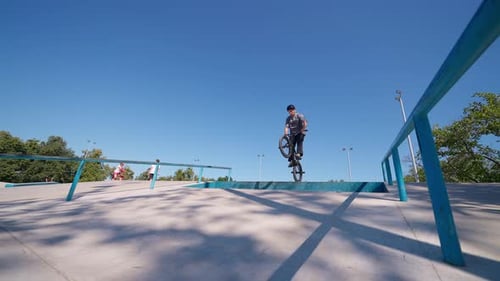 Young Man Doing Bike Stunt in Park