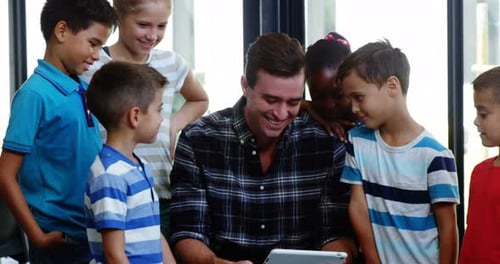 Enthusiastic Students Learn with Teacher and Tablet