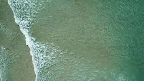 Top View of Waves Break on Tropical White Sand Beach