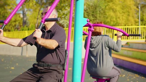 Active Elderly Couple Exercising Outdoors in a Park or Garden