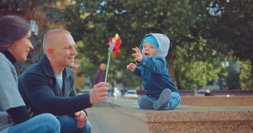 Parents Play with the Kid in the Park
