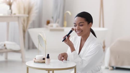 Woman Applies Makeup in Airy Bathroom