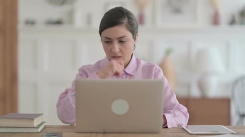 Indian Woman Coughing while using Laptop in Office