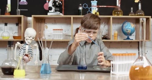 Child Doing Science Experiment in School Lab