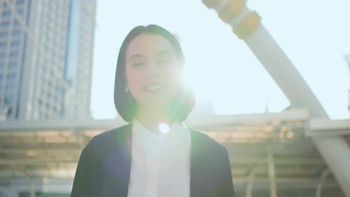 Portrait of Asian young smart business woman working in company office in city and look at camera.